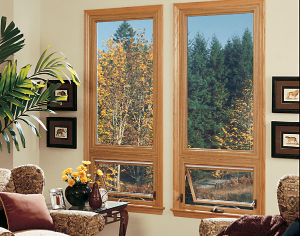 Awning windows with wood frames in the living area of a home
