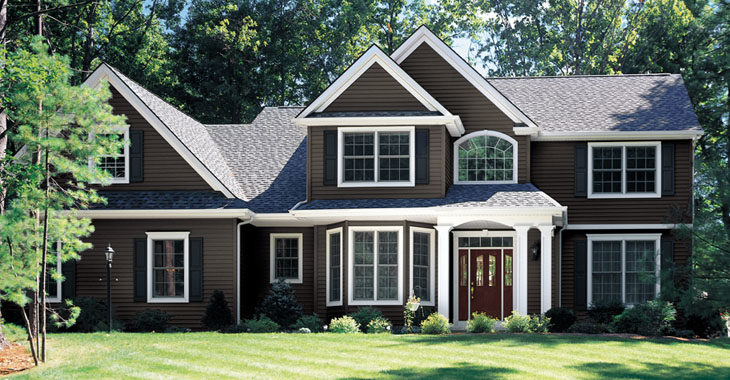 A large suburban home with brown Preservation siding and gorgeous windows