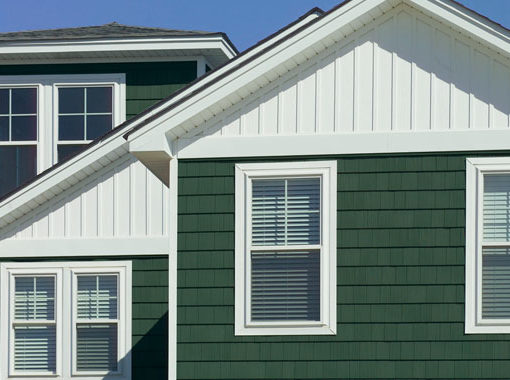 green shake home with white frame windows