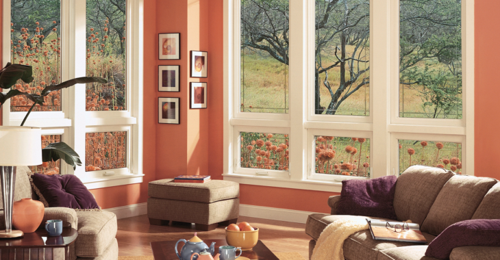 Living room with couch and chair with large windows