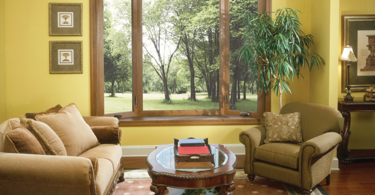 Living room with coffee table and large chairs with gorgeous bay window