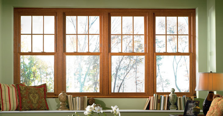 A wall of wood-framed windows in a home